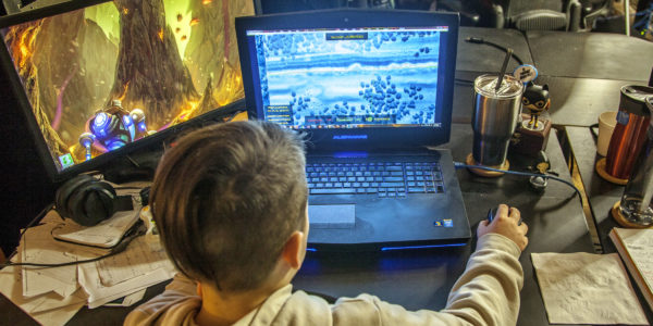 Child playing HEWMEN-enabled games